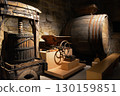 A historic wine cellar with an antique wooden press, grape crusher, and giant barrel. The concept is traditional winemaking heritage and craftsmanship. 130159851
