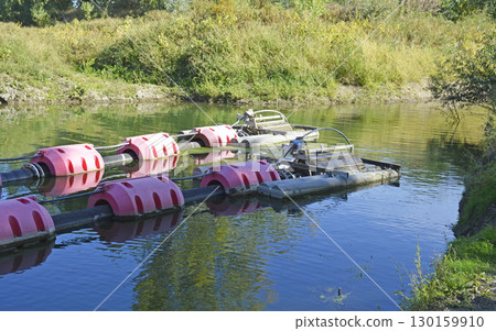 floats with pipes and pumps for water intake from the river floats with pipes and pumps for water intake from the river 130159910