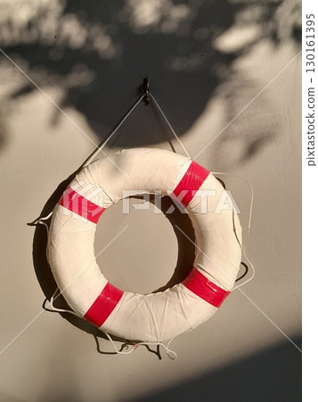 swimming ring on the pool wall for emergencies 130161395