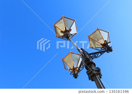 Retro image of street light and blue sky copy space 130161396