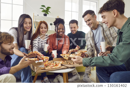 Happy diverse friends having party gathering at home eating pizza talking and laughing together Happy diverse friends having party gathering at home eating pizza talking and laughing together 130161402