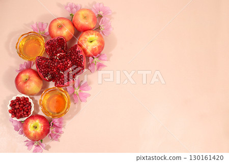 Creative composition for the Jewish holiday Ro Hashanah with a place for congratulations. Layout with traditional symbols of the Jewish New Year, template with honey, apples, pomegranate and flowers Creative composition for the Jewish holiday Ro Hashanah with a place for congratulations. Layout with traditional symbols of the Jewish New Year, template with honey, apples, pomegranate and flowers 130161420