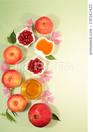 Advertising banner with symbols of the Jewish New Year, template with honey, apples, pomegranate, red wine and flowers. Creative composition for congratulations on the Jewish holiday Ro Hashanah, 130161425