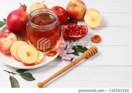 Creative composition for the Jewish holiday Ro Hashanah with a place for congratulations. Layout with traditional symbols of the Jewish New Year, template with honey, apples, pomegranate and flowers 130161428
