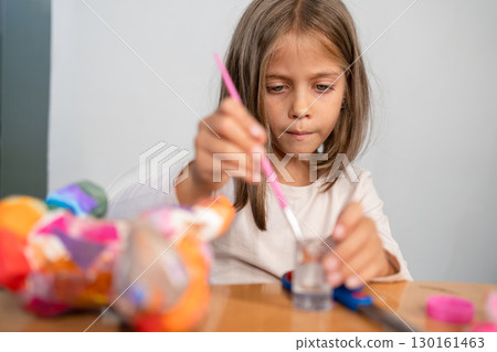 Girl painting ceramic figurine with colorful Girl painting ceramic figurine with colorful 130161463