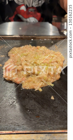 Monjayaki grilled on a hot plate 130162235