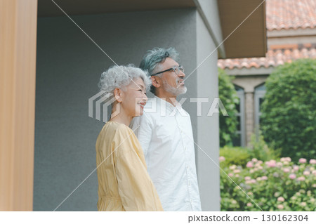 Senior couple looking at their garden Senior couple looking at their garden 130162304