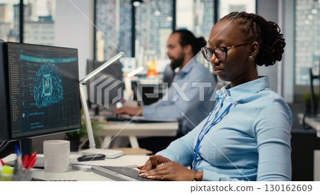 Equity analyst uses AI for companies earnings research to assess stock market value, taking notes. Trader conducts financial analysis to improve investments using artificial intelligence Equity analyst uses AI for companies earnings research to assess stock market value, taking notes. Trader conducts financial analysis to improve investments using artificial intelligence 130162609