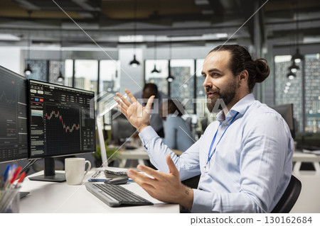 Trader in proprietary firm office analyzing market data and executing trades using trading platform dashboard on PC. Asset management company agent monitoring stock exchange valuation using computer Trader in proprietary firm office analyzing market data and executing trades using trading platform dashboard on PC. Asset management company agent monitoring stock exchange valuation using computer 130162684