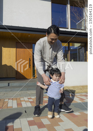 A family standing in front of a family A family standing in front of a family 130164119