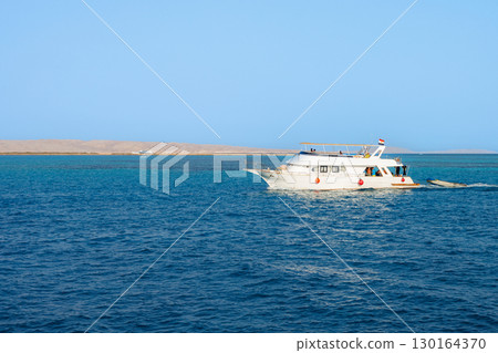 Yacht cruising on clear blue sea 130164370