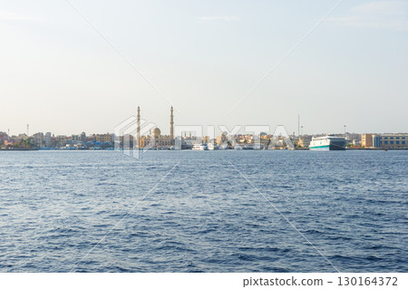 Coastal cityscape with mosque and boats Coastal cityscape with mosque and boats 130164372