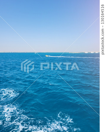 Speedboat on bright blue sea under clear sky 130164516