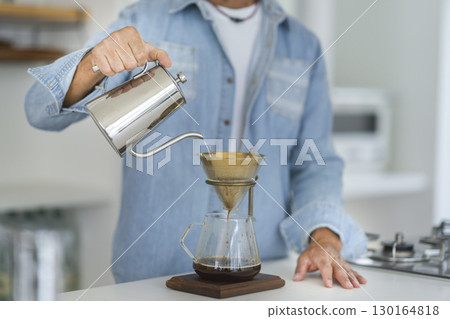 Hands of a senior man making coffee 130164818