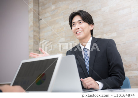 Image of a young salesman explaining to a customer, explanation or presentation Image of a young salesman explaining to a customer, explanation or presentation 130164974