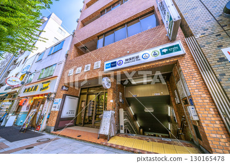 Tokyo cityscape in Japan: Kanda Jinbocho, a used bookstore street lined with shops facing north, and Jinbocho Station Exit A1 130165478