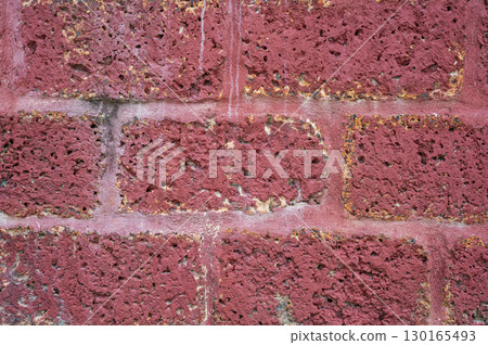 Full frame shot of laterite stone wall textured and background. Laterite stone often used in the construction of temple walls, particularly in Southeast Asia. 130165493