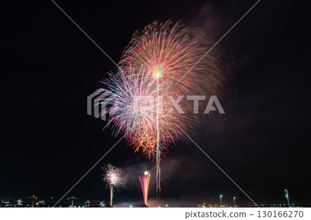Large fireworks blooming in the night sky and Japan's tallest pedestrian bridge Large fireworks blooming in the night sky and Japan's tallest pedestrian bridge 130166270