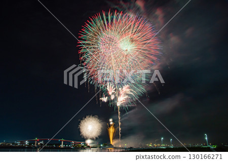 Large fireworks blooming in the night sky and Japan's tallest pedestrian bridge Large fireworks blooming in the night sky and Japan's tallest pedestrian bridge 130166271