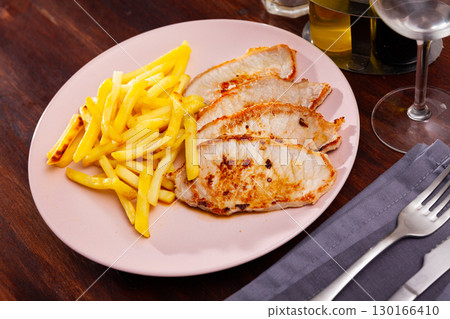 Baked pork meat with garnish of fried potato 130166410