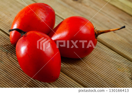 Exotic tropical tamarillo fruit on wooden table Exotic tropical tamarillo fruit on wooden table 130166413
