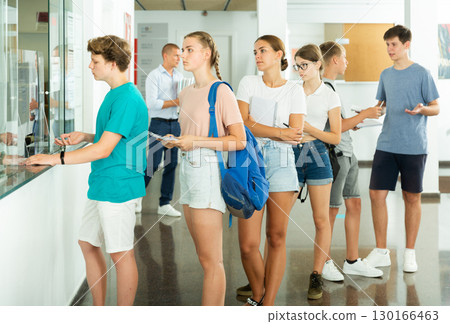 Teenagers applicants submit documents to admissions office of university Teenagers applicants submit documents to admissions office of university 130166463