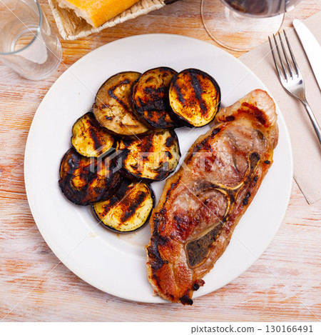 Close-up of delicious grilled pork with eggplant at plate 130166491