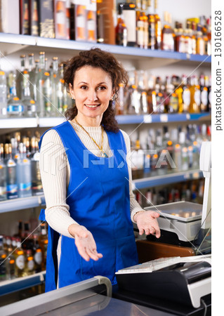 Adult saleswoman posing at store counter 130166528