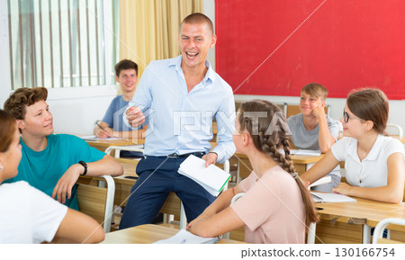 Teacher and young students smiling 130166754