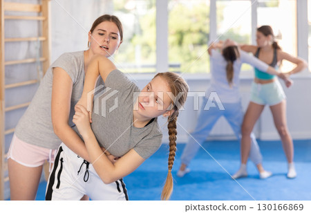 Females practicing self defence moves 130166869