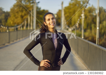 Portrait of happy smiling sporty woman looking at camera after sport fit exercises outdoors. Portrait of happy smiling sporty woman looking at camera after sport fit exercises outdoors. 130166982