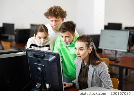 Teen schoolchildren learning basics of programming with female teacher 130167025