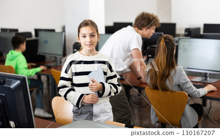 Portrait of schoolgirl girl in computer class at school 130167207