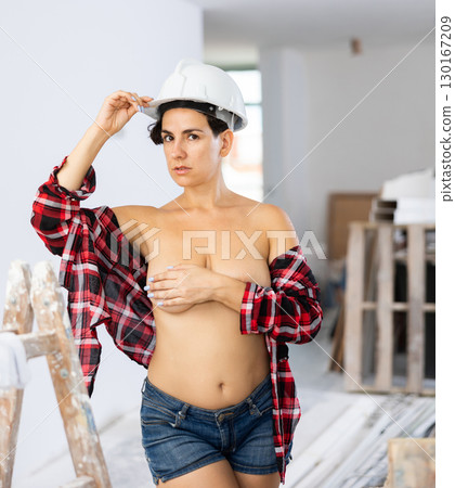 Portrait of a half-naked girl in short shorts in renovated room Portrait of a half-naked girl in short shorts in renovated room 130167209