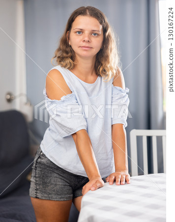 Young adult woman posing in living room 130167224