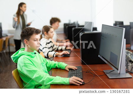 Portrait of students at computers in computer class 130167281