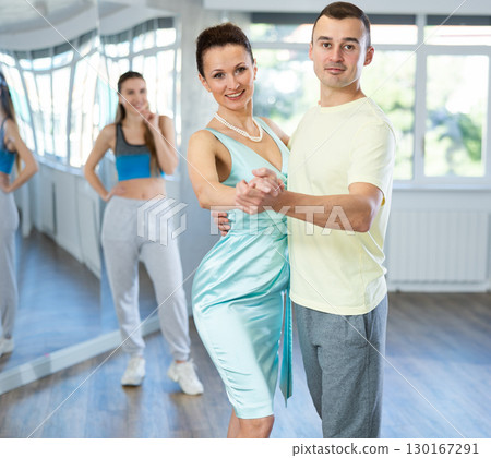 Female dance instructor showcasing waltz moves with male student 130167291
