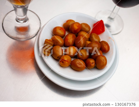 Pickled olives with a stone - a typical Spanish tapas. 130167376