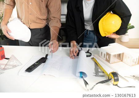 Architects Collaborating on Building Plans and Models Architects Collaborating on Building Plans and Models 130167613