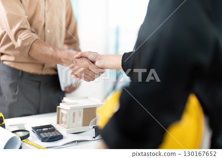 Professional Agreement. Engineer and architect shaking hands on project deal. Professional Agreement. Engineer and architect shaking hands on project deal. 130167652