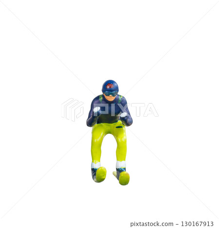 Miniature skier figure standing alone on white background with clean clipping path Miniature skier figure standing alone on white background with clean clipping path 130167913