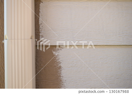 House exterior renovation with freshly painted siding and new trim in a suburban neighborhood House exterior renovation with freshly painted siding and new trim in a suburban neighborhood 130167988