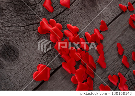 Red Fabric Hearts Scattered on Rustic Wooden Surface for Romantic Decor Theme 130168143