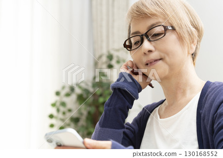 A senior woman operating a computer 130168552
