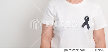 Elderly with Black ribbon for May Melanoma and skin cancer Awareness month, October Vaccine injury awareness month, Mourning Remembrance, March Sleep awareness week, Gang Prevention and Anti Violence 130169563