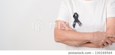Elderly with Black ribbon for May Melanoma and skin cancer Awareness month, October Vaccine injury awareness month, Mourning Remembrance, March Sleep awareness week, Gang Prevention and Anti Violence 130169564