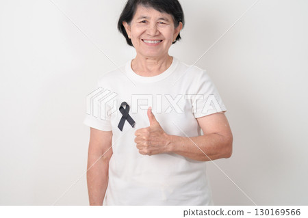Elderly with Black ribbon for May Melanoma and skin cancer Awareness month, October Vaccine injury awareness month, Mourning Remembrance, March Sleep awareness week, Gang Prevention and Anti Violence 130169566