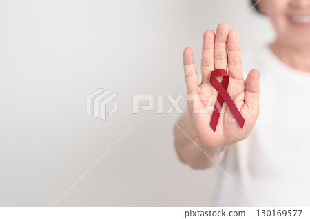 Elderly with Burgundy Ribbon for March Multiple Myeloma Cancer Awareness month, September Sickle Cell Anemia, Headache and Migraine week, April world Meningitis day, October Hospice  Palliative care 130169577