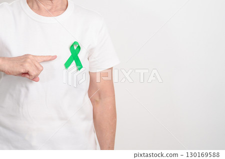 Elderly with Green Ribbon for concept of July Eye Injury Prevention month, January Glaucoma Awareness month, February Gallbladder and Bile duct and October Liver cancer. Health and world cancer day Elderly with Green Ribbon for concept of July Eye Injury Prevention month, January Glaucoma Awareness month, February Gallbladder and Bile duct and October Liver cancer. Health and world cancer day 130169588