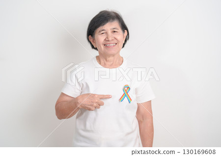 Elderly with LGBTQ Rainbow ribbon for concept of June Pride month, April Autism Awareness, All cancer Awareness, February World Cancer day, October World Hospice and Palliative care day and Survivor Elderly with LGBTQ Rainbow ribbon for concept of June Pride month, April Autism Awareness, All cancer Awareness, February World Cancer day, October World Hospice and Palliative care day and Survivor 130169608